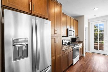 A kitchen with wooden cabinets and stainless steel appliances
